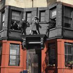 March 19, 1942. 497 Dean Street. Edna Egbert proudly displayeda blue star banner in her window, in honor of her son being in the service. However, after not hearing fom him since his enlistement, she became distraught and climbed out onto her ledge. Cops Ed Murphy and George Munday distracted her so she could be pushed into a safety net, the precursor of today’s standard airbags.
